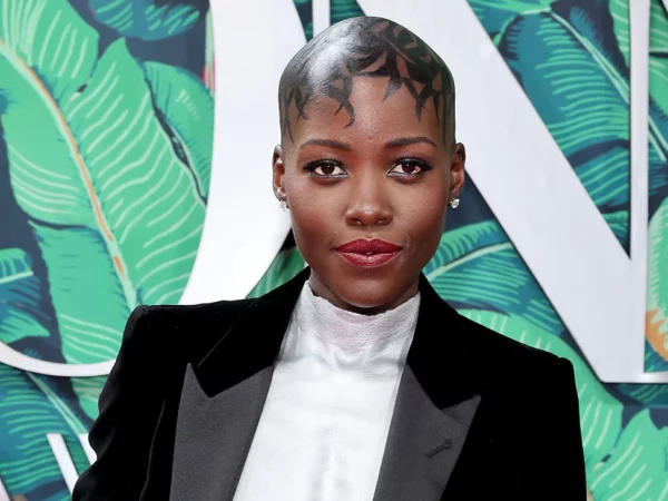Lupita Nyong’o Suits Up in Black Velvet Ensemble With Custom Breastplate at the Tony Awards 